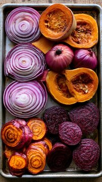 Assorted sliced vegetables roasted on metal baking sheet