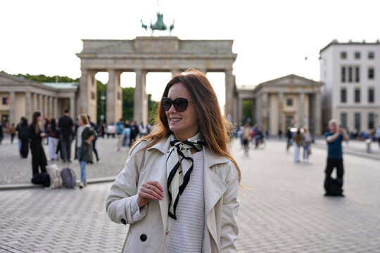 Smiling woman in sunglasses at Brandenburg Gate in Berlin