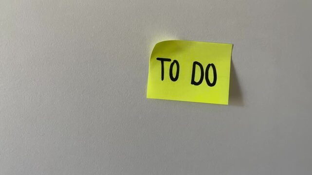 To do list sticky note stuck on white wall