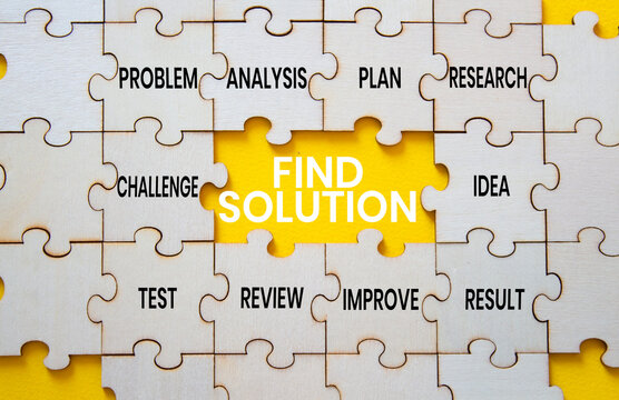 Find solution symbol. Concept words find solution on wooden puzzle pieces. Beautiful yellow background. Problem solving concept. Copy space.