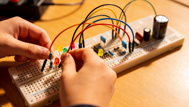 Close up of kids building a circuit with colorful components
