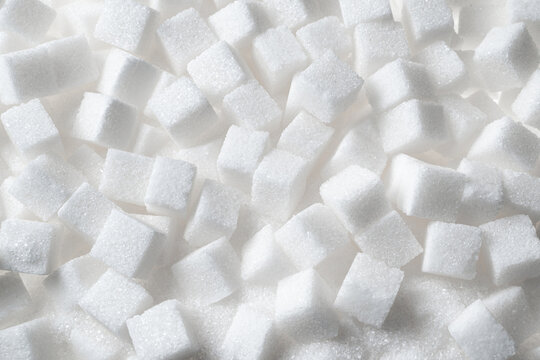 White refined sugar cubes background macro