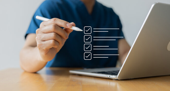 close up young general practitioner hand use stylus pen to check box on medical chekclist or opd record to read and diagnose and assess about patient's symptom for healthy and lifestyle concept
