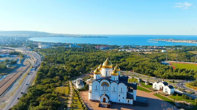 Gelendzhik, Russia. Cathedral of St. Andrew the First-Called. The text along the M4-Don Highway is translated: Glory to Russia, Kuban-Pearl of Russia. Gelenzhik-City Resort. Drone footage, Departure 