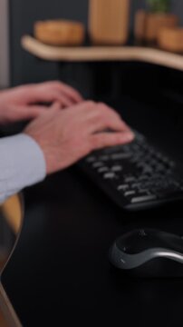 black keyboard, keyboard typing, office keyboard. Hands type on black keyboard at modern ergonomic workstation while computer mouse appears in foreground.