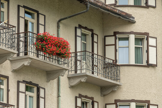 Cortina d'Ampezzo, Italy. Traditional Alpine facade with ornate balconies and red flowers