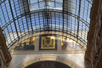 Arched glass roof and decorative mosaic panels with heraldic crest in galleria vittorio emanuele ii interior for architectural wallpaper and banner © iri.madrid.art
