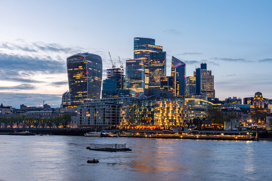 City of London skyscrapers and Thames river at sunset, UK