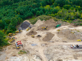 aerial view of working backhoe digging soil and dump truck at construction site © nd700