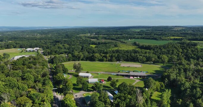 Trumansburg, NY, USA - August 21, 2026 - Afternoon aerial video, dolly forward with slight pan, of the village of Trumansburg on a sunny summer day, 4096 x 2160, Frame rate 29.97 fps.