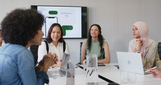 Four women African descent meeting room screen sparking app left woman leaning gesturing