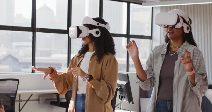 Diverse female team upon VR headset activation, performing VR demo at office with tablet monitoring