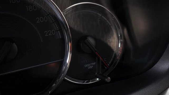 Close-up of car dashboard showing illuminated door lock security warning indicator