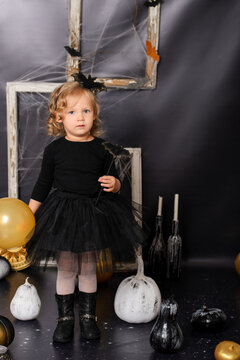 Cute Toddler Girl in Black Tutu Dress Holding Magic Wand for Halloween