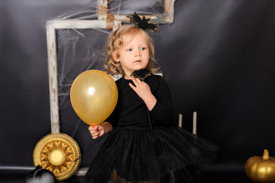 Cute Toddler Girl in Black Tutu Dress Holding Magic Wand for Halloween