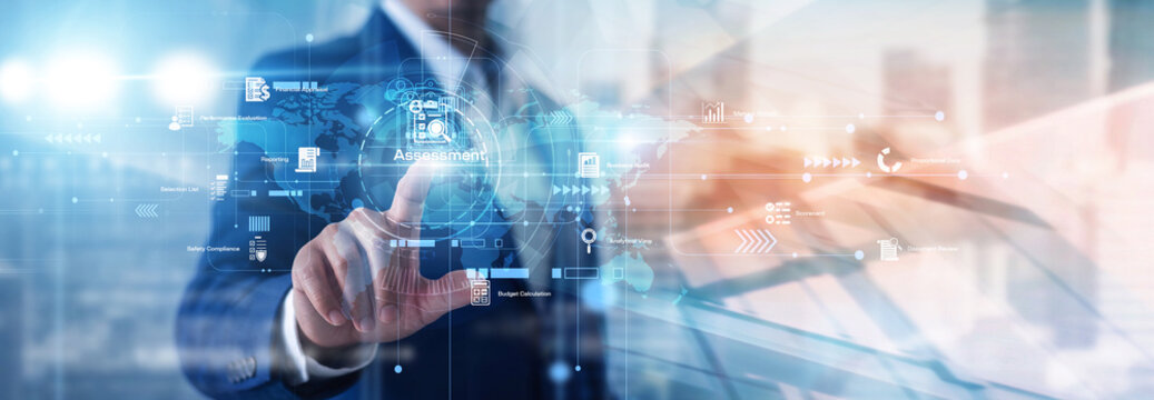 Business analyst touching the concept of Assessment, mapping performance scores and evaluation charts on a network of measurable indicators. Assessment advances clearer performance reviews.