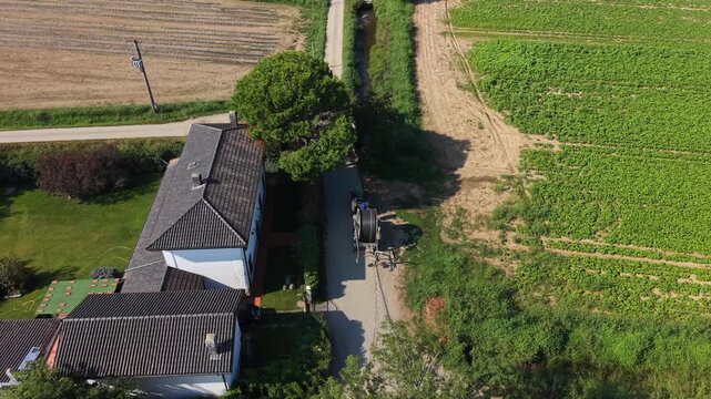 Rural Tranquility: An aerial view showcases a quaint rural property nestled amidst verdant fields, with a winding path leading to the isolated homestead.