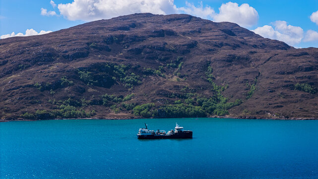 Aerial view of a ship in Ullapool bay, Scotland 