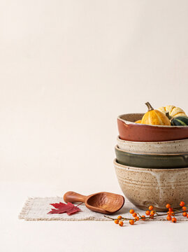 Thanks giving poster with text space, Harvest Bounty in Ceramic Bowls: A charming still life arrangement featuring miniature pumpkins and squash nestled within rustic ceramic bowls