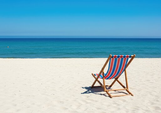 A tranquil coastal scene featuring a striped lounge chair set up on pristine white sand, overlooking the vast blue ocean under a clear summer sky ,sunlight ,relaxation ,calm