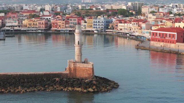  View of Chania with the amazing lighthouse, mosque, venetian shipyards, Crete, Greece.Waves crashing on lighthouse, Beautiful Greece and best scenic places - panorama
