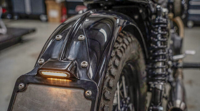 Motorcycle license plate bracket and rear fender detail on a custom chopper bike