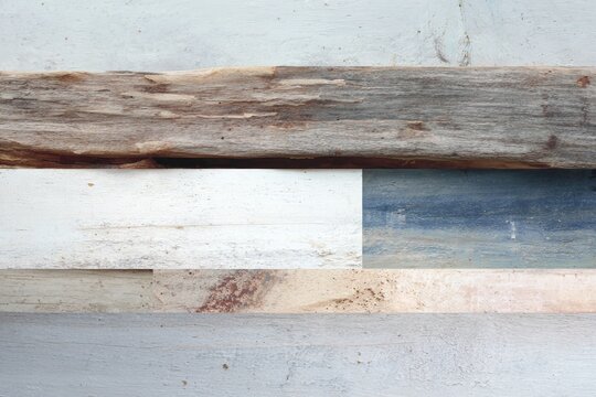 Worn reclaimed wood plank collage with weathered paint tones and coastal textures for rustic beach background and panel design with driftwood appeal