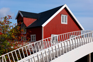 Traditional red wooden house with white bridge in Stamsund, Lofoten Islands, Norway © Comofoto