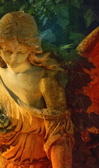 Obraz premium Beautiful stone angel statue surrounded by ivy in warm golden light, symbolizing peace, faith, hope, spiritual protection and eternal memory.