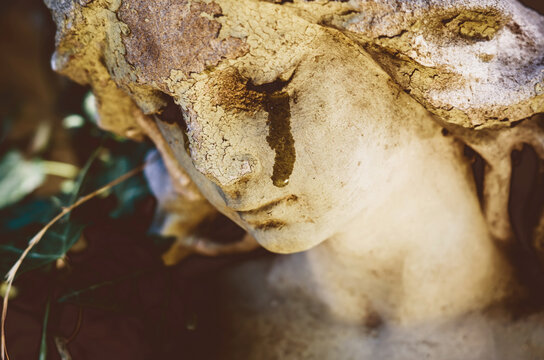 Weeping angel statue with tears on its face, emotional symbol of grief, sorrow, mourning, loss and remembrance.