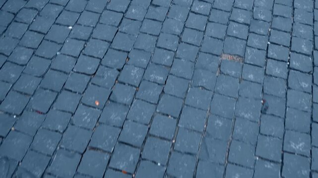 A sidewalk laid with yellow, red, grey and white colors paving stone forming colorful shapes and pointing the way for visitors of Long Son Pagoda in Nha Trang, Vietnam. Shot in motion
