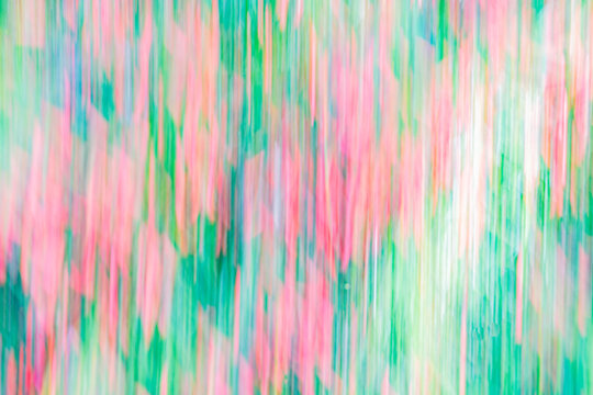 Vibrant red and green abstract garden background with soft motion. Small red cigar flower and green foliage impressionist style