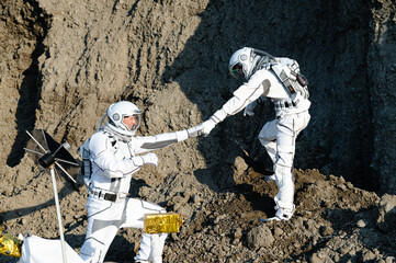 Two astronauts work together on the lunar surface during a space exploration mission © Kokhan O