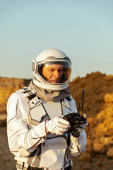 Mars astronaut conducts research using technology in a dusty environment during daylight © Kokhan O