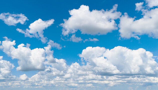 Blue sky with white cumulus clouds. Peaceful and serene sky with clouds background. Sky with white clouds. Sky and clouds.