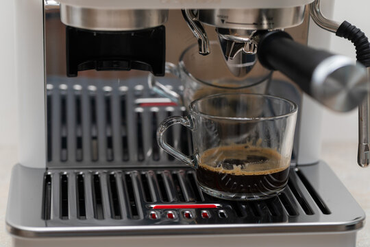 Fresh Espresso Brewing into Glass Cups from Coffee Machine
