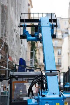 Blue Telescopic Handler at an Urban Building Renovation Site