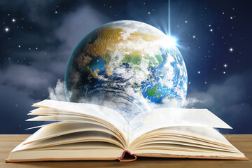 Obraz premium Open book on table against planet in space