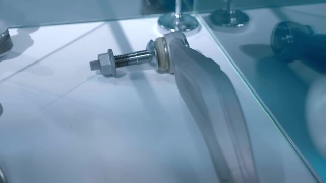 Samples of new ball joints, levers and other vehicle suspension components are on display at the exhibition. Closeup. Shot in motion