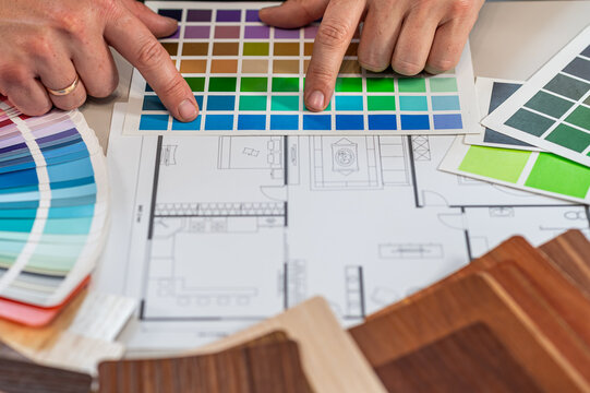 Professional Architect Hands Selecting Color Swatches on Interior Project Sketch Close up
