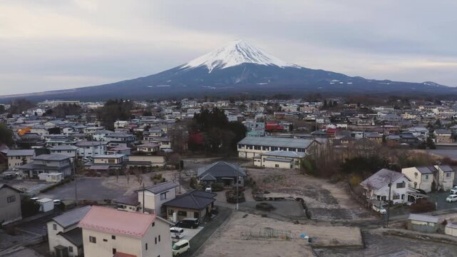 Aerial View of Fujikawaguchiko Townscape and Mount Fuji Under Hazy Blue Sky