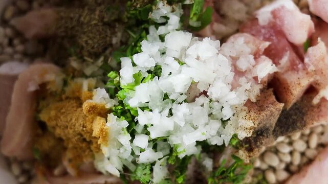 Overhead Zoom In Shot of Diced Onions, Herbs, Raw Pork, and White Beans in Slow Cooker Pot