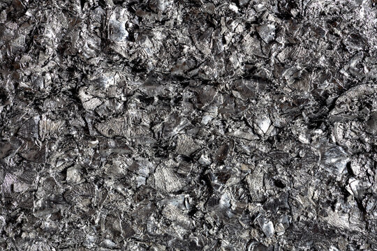 Abstract background of metal scrap and shavings, texture of industrial material, with silvery tones and irregular surfaces
