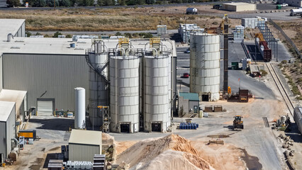 Industrial plant processing raw materials with silos and railway © SNEHIT PHOTO