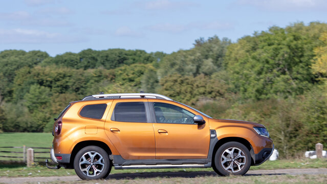 Milton Keynes; UK - Sept. 20th 2026: 2019 orange  Dacia Duster car driving on a British road