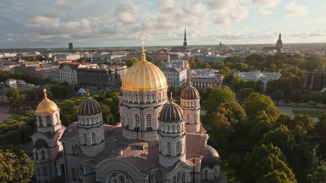 Orthodox cathedral golden domes and city panorama from drone, Riga. Aerial shot circling the golden domed Nativity of Christ Cathedral in Riga, Latvia, with parks, boulevards.