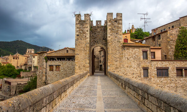 View from the medieval bridge toward the historic gate and village of Besal&uacute; in Catalonia, Spain.