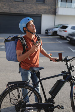 Delivery service courier checking address on smartphone app