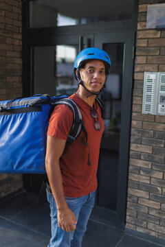 Food delivery courier arrives at destination with delivery bag