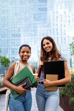 Diverse female students smiling together on university campus